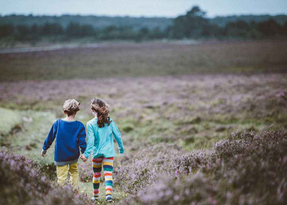 two kids holding hands